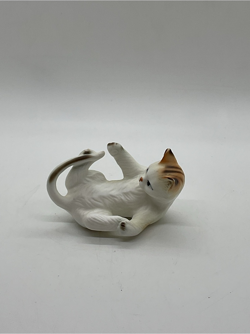 White and Tan Ceramic Cat Figurine - Catching Its Tail